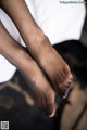 A close up of a woman's feet with black stockings.