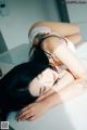 A woman laying on top of a white table.